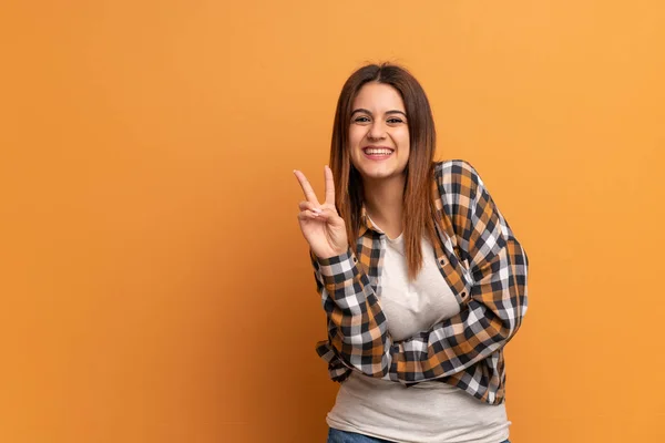 Jovem Mulher Sobre Parede Marrom Sorrindo Mostrando Sinal Vitória — Fotografia de Stock