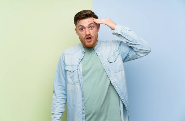 Renkli arka plan üzerinde Redhead adam sadece bir şey fark etti ve çözüm niyetinde