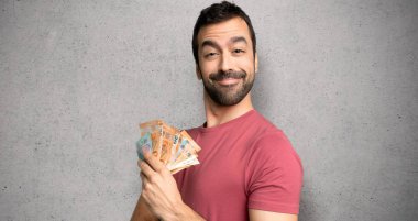 Dokulu duvar üzerinde gülümsüyor iken adam silah tutarak çok para alarak lateral pozisyonda geçti