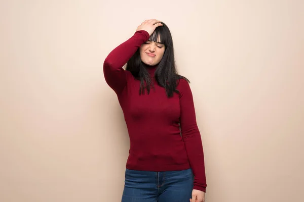 Young woman with red turtleneck with surprise and shocked facial expression