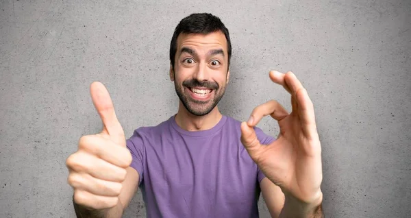 Handsome Man Showing Sign Giving Thumb Gesture Textured Wall — Stock Photo, Image