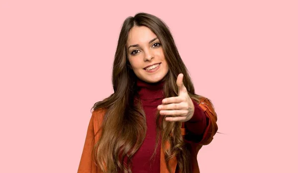 Junge Frau Mit Mantel Schüttelt Hände Vor Isoliertem Rosa Hintergrund — Stockfoto