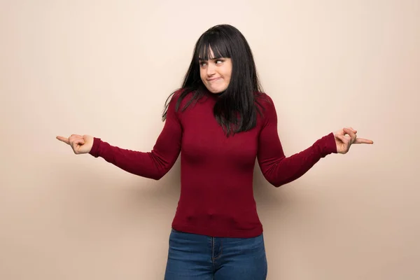 Young Woman Red Turtleneck Pointing Laterals Having Doubts — Stock Photo, Image