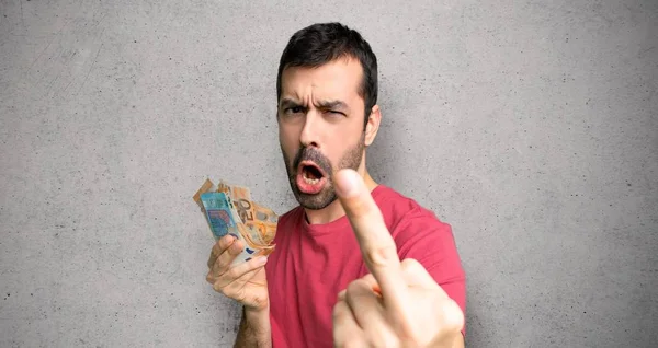 Hombre Tomando Montón Dinero Haciendo Gesto Cuerno Sobre Pared Texturizada — Foto de Stock