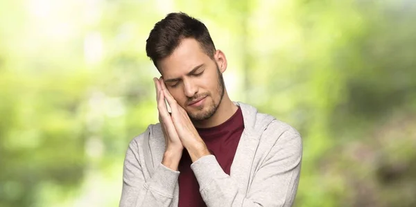 Man Sweatshirt Making Sleep Gesture Dorable Expression Park — Stock Photo, Image