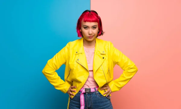 Young woman with yellow jacket angry