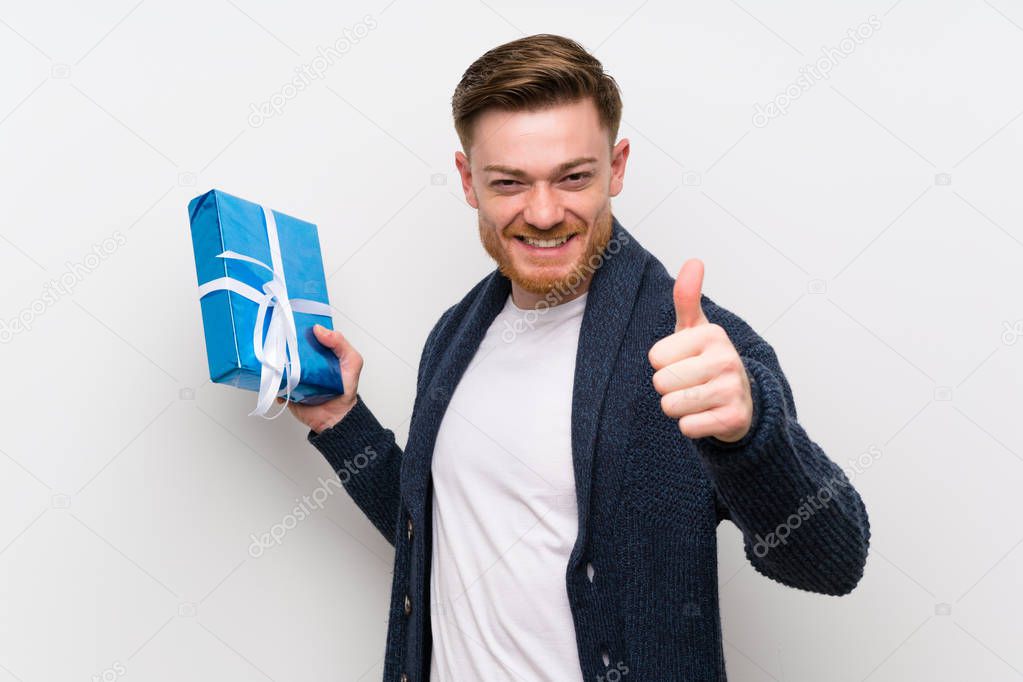 Redhead man holding a gift