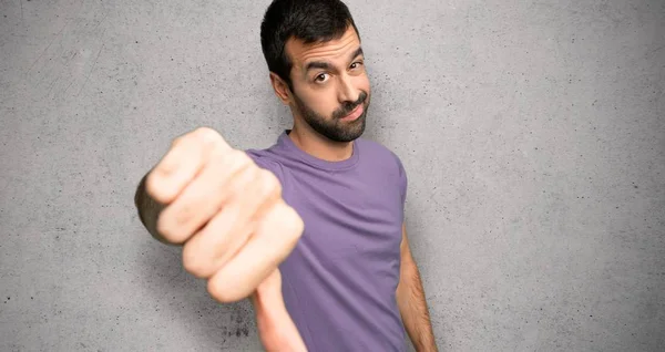 Handsome Man Showing Thumb Sign Negative Expression Textured Wall — Stock Photo, Image