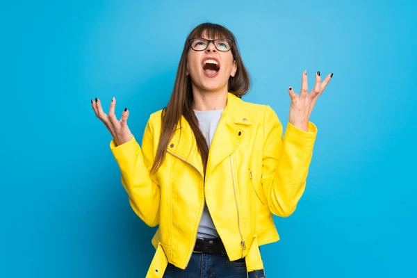 Young Woman Yellow Jacket Blue Background Smiling Sweet Expression — 스톡 사진