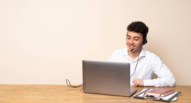 Telemarketer adam kalça kolları ile poz ve gülümseyerek