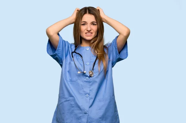 Jovem Enfermeira Toma Mãos Cabeça Porque Tem Enxaqueca Fundo Azul — Fotografia de Stock