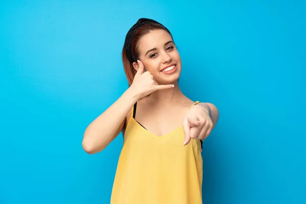 Young Redhead Woman Blue Background Making Phone Gesture Pointing Front — Stock Photo, Image