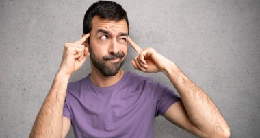 Yakışıklı adam şüpheleri olan ve dokulu duvar üzerinde düşünme