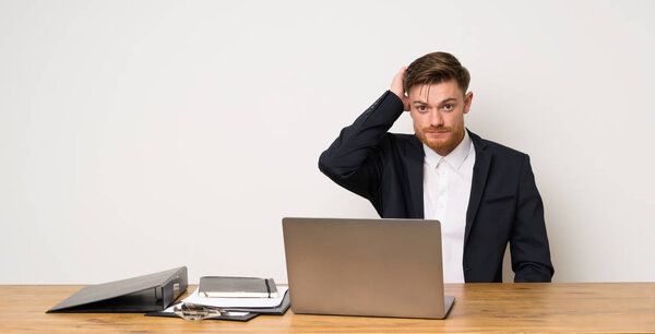 Businessman in a office with an expression of frustration and not understanding