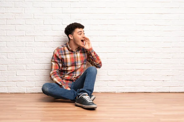 Mladý Muž Sedí Podlaze Křičí Pusou Dokořán Příčném — Stock fotografie