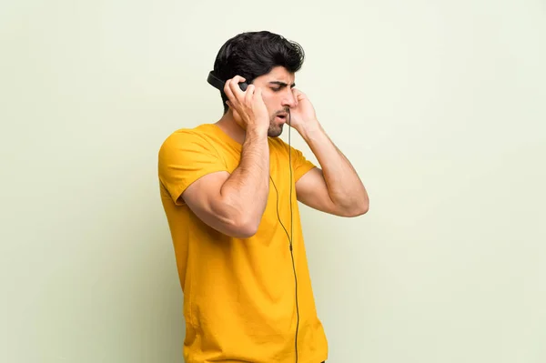 Joven Sobre Pared Rosa Escuchando Música Con Auriculares — Foto de Stock