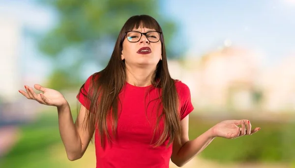 Woman with glasses unhappy because not understand something at outdoors