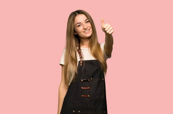 Young Woman Apron Giving Thumbs Gesture Because Something Good Has — Stok fotoğraf