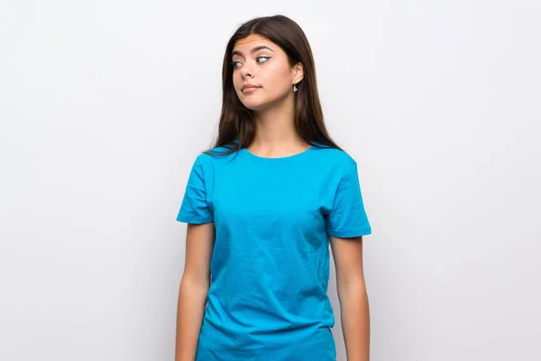 Teenager Girl Blue Shirt Making Doubts Gesture Looking Side — Stock Photo, Image