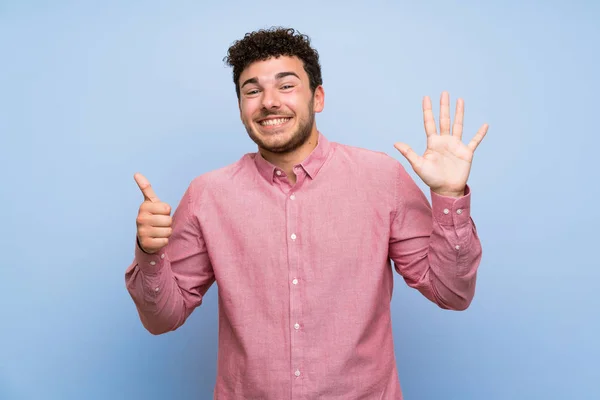 Man Curly Hair Isolated Blue Wall Counting Six Fingers — Stock Photo, Image