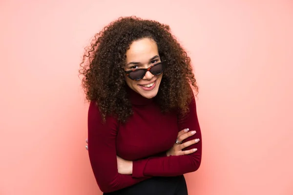 Dominican woman with turtleneck sweater laughing