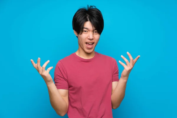 Asian Man Red Shirt Isolated Blue Wall Unhappy Frustrated Something — Stock Photo, Image