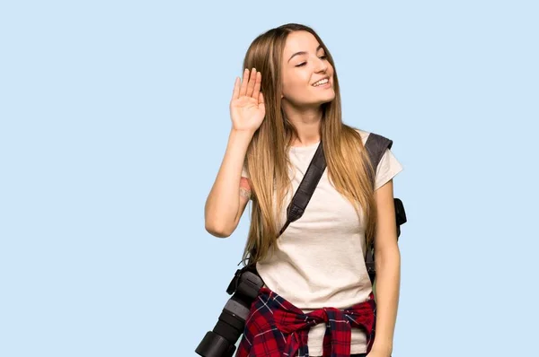 Young Photographer Woman Listening Something Putting Hand Ear Isolated Blue — 스톡 사진