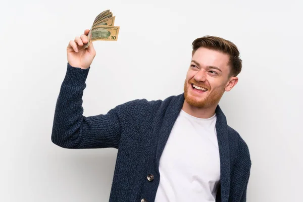 Pelirrojo hombre tomando un montón de dinero —  Fotos de Stock