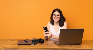 İş kadını bir ofiste mobil ileti gönderme