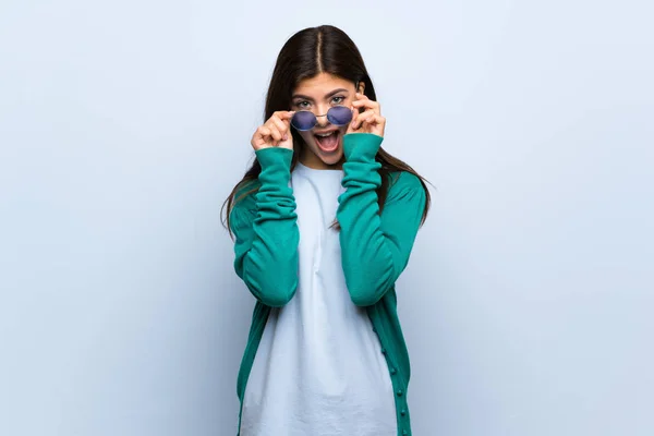 Teenager Mädchen Mit Brille Über Blaue Wand Und Überrascht — Stockfoto