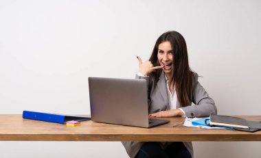 Ofiste telefon hareketi yapan iş kadını. Beni geri arayın işareti