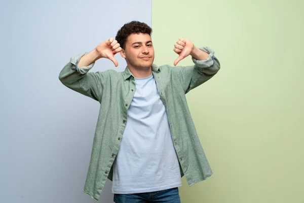 Young Man Blue Green Background Showing Thumb Both Hands — Stock Photo, Image