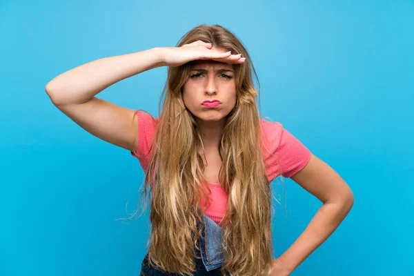 Mujer Rubia Joven Con Overoles Sobre Una Pared Azul Aislada — Foto de Stock