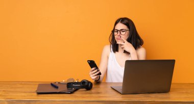 İş kadını bir ofiste düşünme ve ileti gönderme