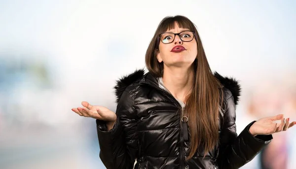 Woman with glasses unhappy because not understand something at outdoors