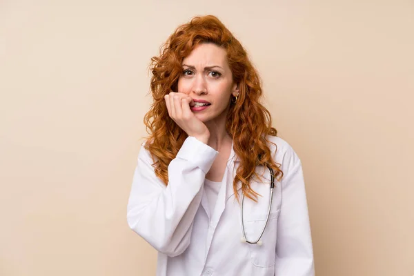 Redhead doctor woman nervous and scared