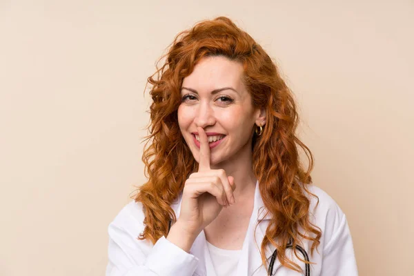 Redhead doctor woman doing silence gesture