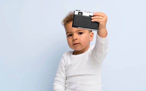 Bambino Isolato Sfondo Blu Che Tiene Una Fotocamera — Foto Stock