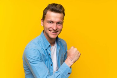 Bir zafer kutluyor izole duvar üzerinde sarışın yakışıklı adam