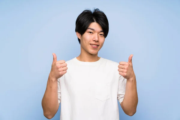 Asian Man Isolated Blue Background Giving Thumbs Gesture — Stock Photo, Image