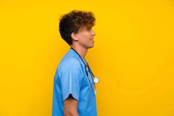 Surgeon doctor african american man standing and looking to the side