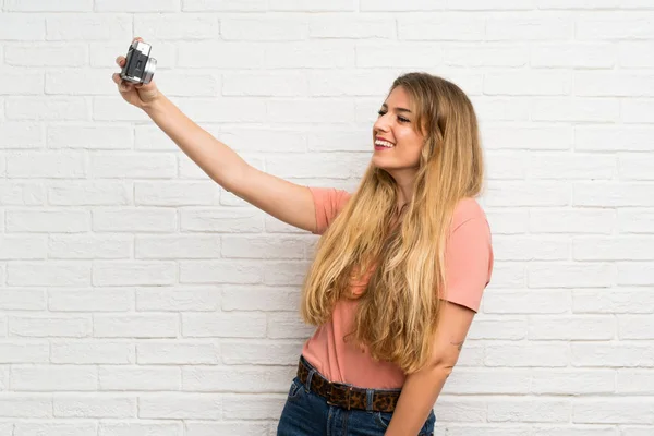 Young Blonde Woman White Brick Wall Making Selfie — Stock Photo, Image
