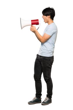 Izole beyaz arka plan üzerinde bir megafon ile bağıran mavi gömlekli Asyalı bir adamın tam uzunlukta bir çekim
