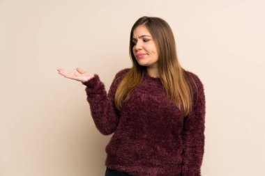 Young girl holding copyspace with doubts