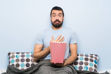 Sakallı bir adam patlamış mısır yiyor