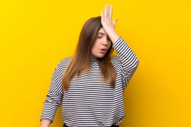 Young girl over yellow wall has realized something and intending the solution