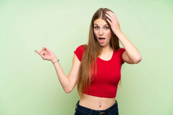Young Woman Long Hair Isolated Green Wall Surprised Pointing Finger — 스톡 사진