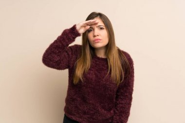 Young girl looking far away with hand to look something