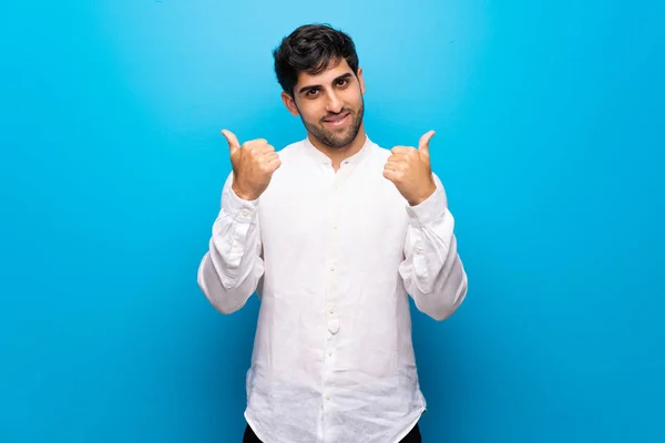 Young Man Isolated Blue Wall Giving Thumbs Gesture Both Hands — Stock Photo, Image