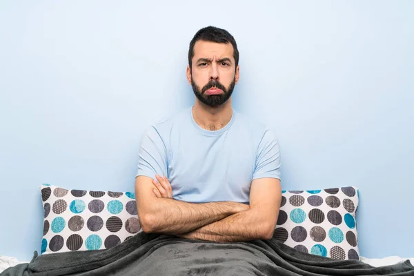 Man in bed with sad and depressed expression